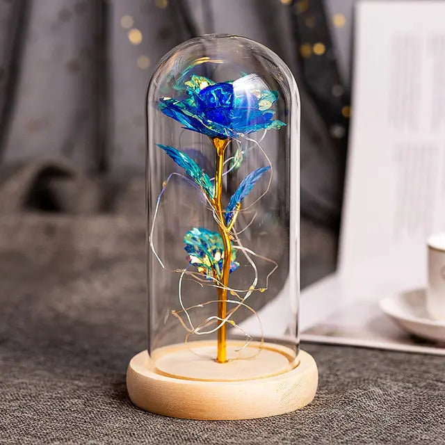 Decorative artificial flowers encased in a glass dome for an elegant touch.