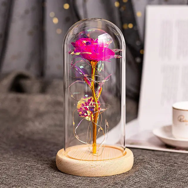 Enhance your home with a chic artificial flower arrangement in a glass dome.